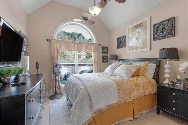 bedroom with ceiling fan, lofted ceiling, and light hardwood / wood-style floors