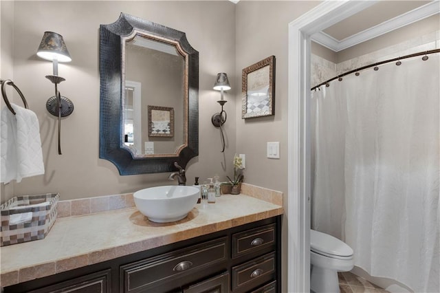 bathroom featuring vanity, ornamental molding, and toilet