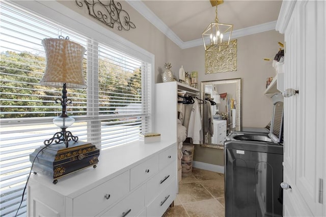 spacious closet with an inviting chandelier and washing machine and dryer