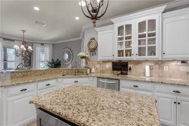 kitchen with sink, dishwasher, hanging light fixtures, white cabinets, and a chandelier