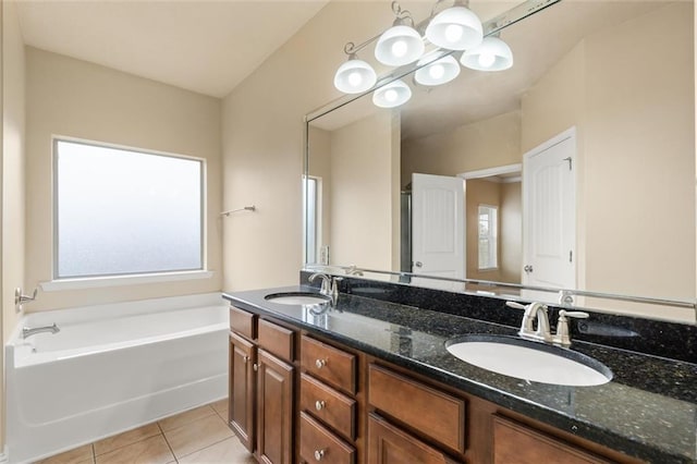 bathroom with tile patterned flooring, vanity, and a bathing tub