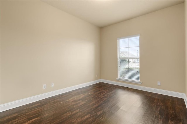 empty room with dark hardwood / wood-style floors