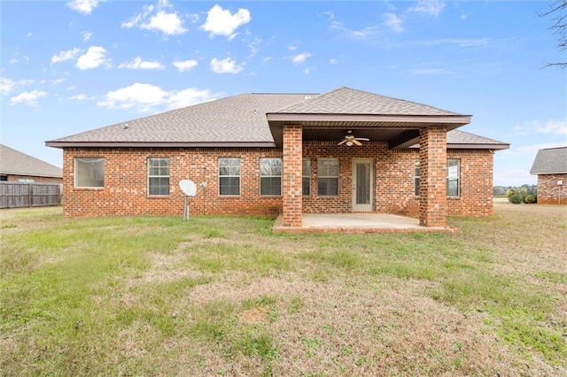 back of property featuring a yard, ceiling fan, and a patio