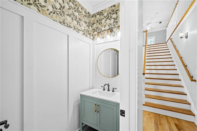 bathroom with ornamental molding, vanity, and hardwood / wood-style floors