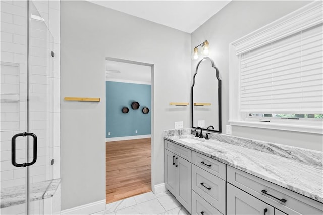 bathroom with wood-type flooring, vanity, and a shower with door