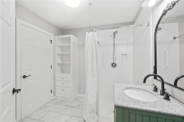 bathroom featuring walk in shower and vanity