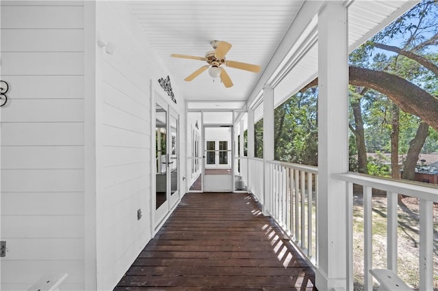 deck with ceiling fan and covered porch