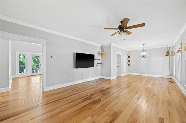 unfurnished living room featuring ceiling fan with notable chandelier, light wood-type flooring, and ornamental molding