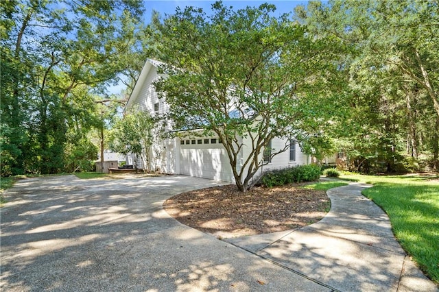 view of property exterior with a yard and a garage