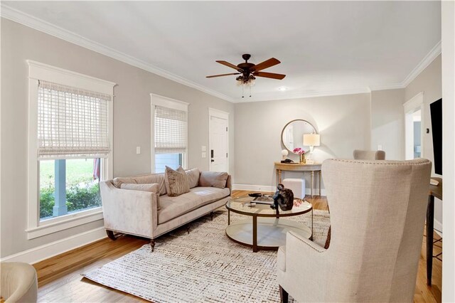 unfurnished living room with ceiling fan, crown molding, and light hardwood / wood-style floors