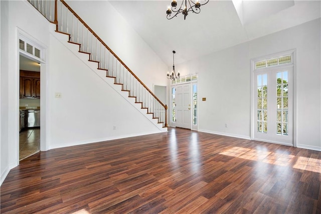 foyer featuring an inviting chandelier, dark hardwood / wood-style flooring, and high vaulted ceiling