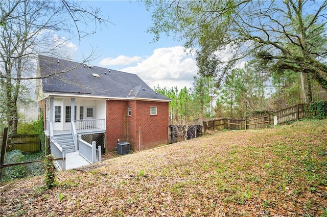 rear view of property featuring central AC