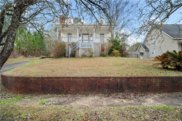 view of yard featuring covered porch