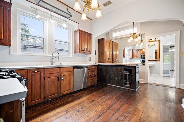 kitchen with sink, an inviting chandelier, dark hardwood / wood-style floors, pendant lighting, and stainless steel appliances