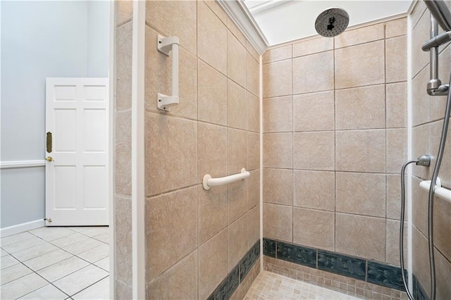 bathroom with tiled shower and tile patterned floors