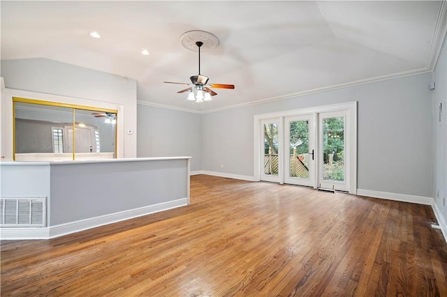 unfurnished living room featuring vaulted ceiling, ornamental molding, wood-type flooring, and ceiling fan