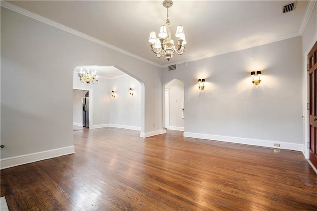 unfurnished living room with crown molding, dark hardwood / wood-style floors, and a notable chandelier