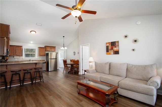 living room featuring dark wood-style floors, high vaulted ceiling, visible vents, and a ceiling fan