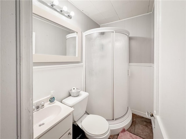 full bathroom featuring vanity, toilet, a stall shower, and tile patterned flooring