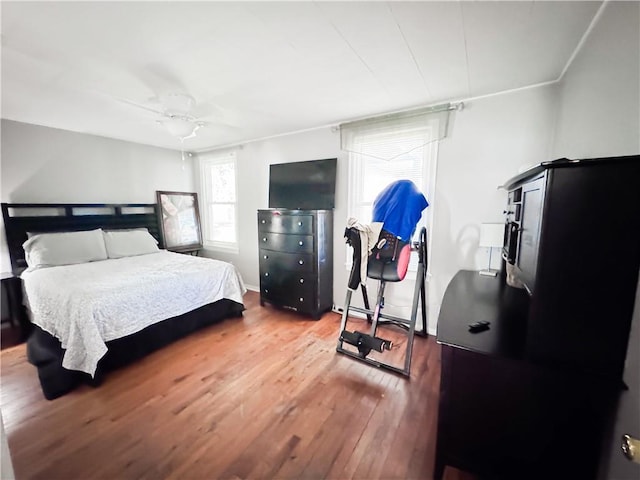 bedroom featuring baseboards and wood finished floors