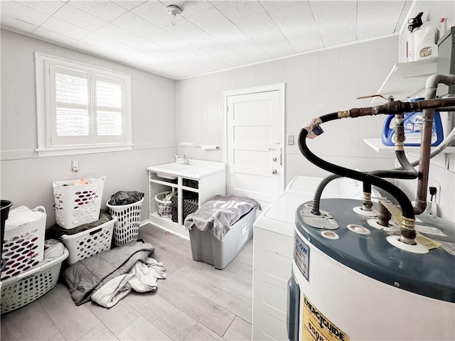 misc room featuring water heater and light wood-type flooring