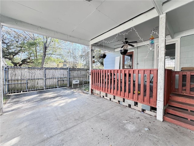 view of patio / terrace with a porch, a ceiling fan, and fence