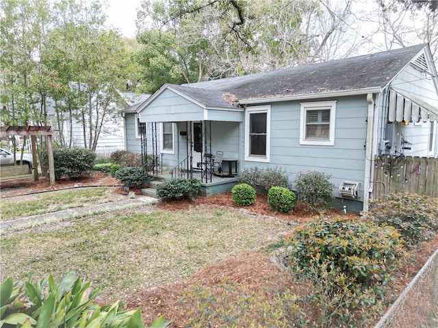 bungalow-style house featuring covered porch and roof with shingles