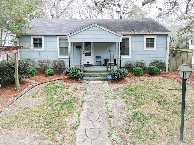 view of front facade with a porch and a shingled roof