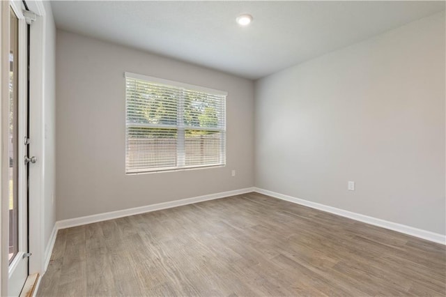 unfurnished room with wood-type flooring