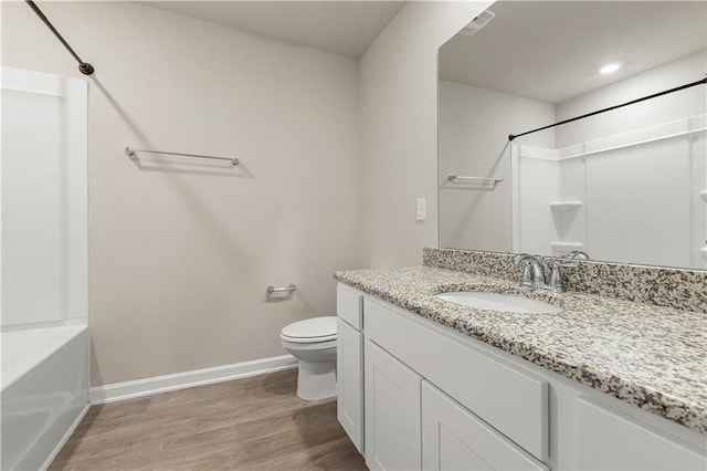 bathroom featuring vanity, hardwood / wood-style flooring, and toilet