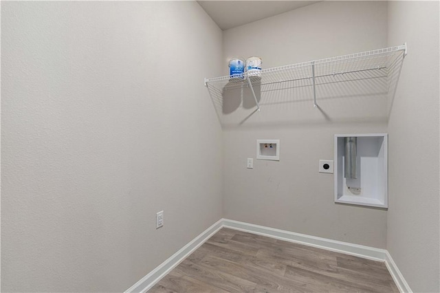 laundry room with hookup for an electric dryer, washer hookup, and wood-type flooring