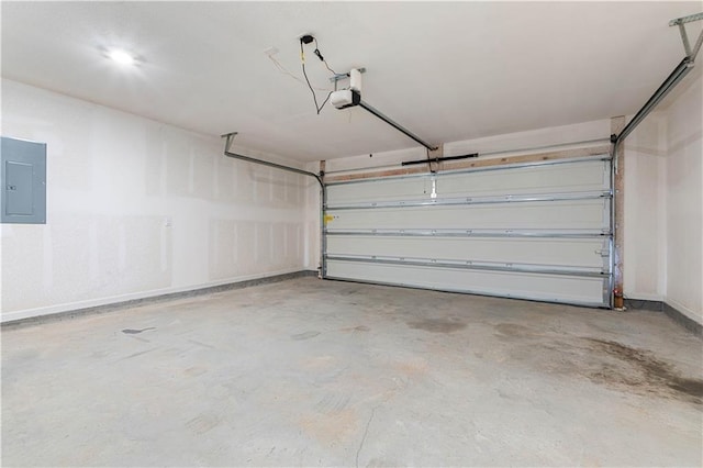 garage with a garage door opener and electric panel