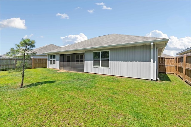 back of house featuring a lawn