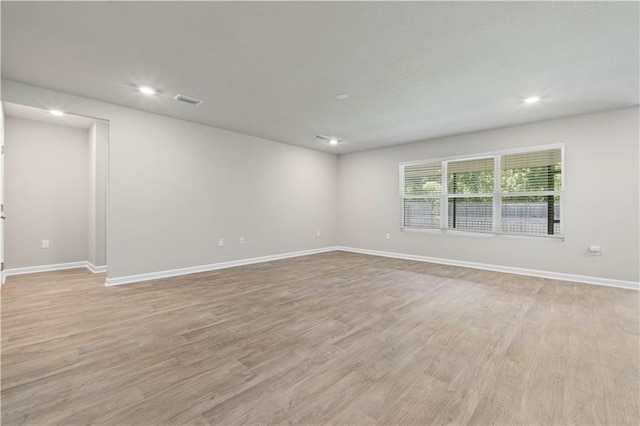 unfurnished room with light hardwood / wood-style floors