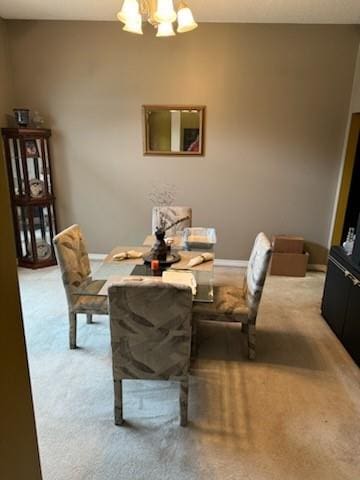 carpeted dining area with a notable chandelier