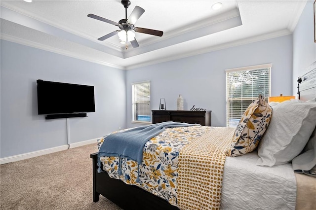 carpeted bedroom featuring crown molding, ceiling fan, and a tray ceiling