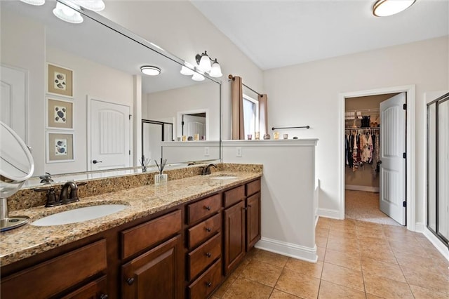 bathroom featuring vanity, an enclosed shower, and tile patterned flooring