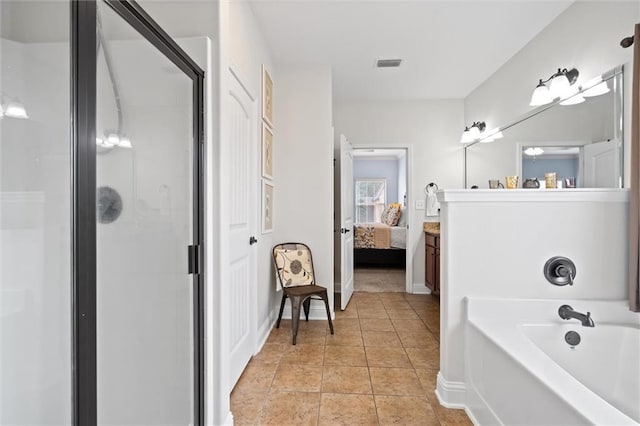 bathroom featuring tile patterned flooring, vanity, and separate shower and tub