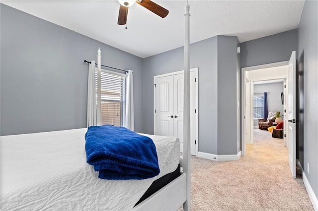 bedroom featuring ceiling fan, a closet, and light carpet