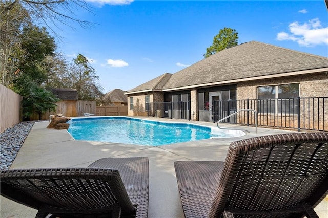 view of swimming pool with a storage shed and a patio area