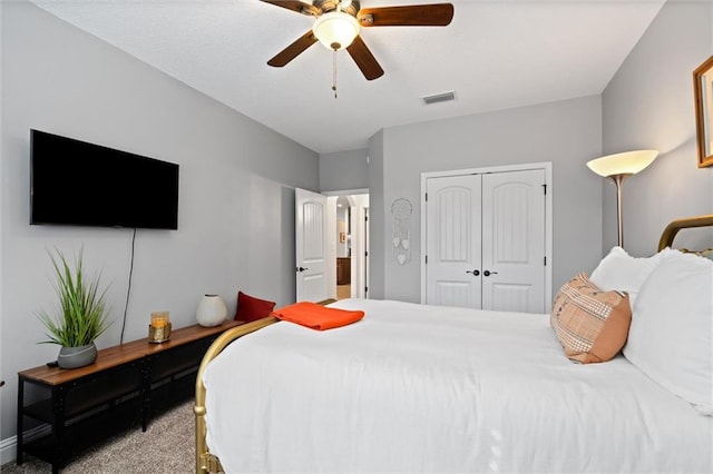 bedroom with ceiling fan, carpet flooring, and a closet