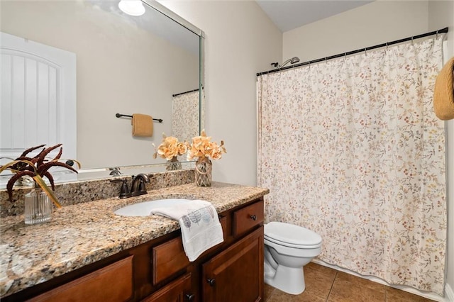 bathroom featuring vanity, toilet, and tile patterned flooring