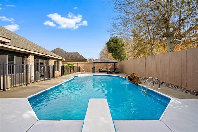 view of pool with a gazebo, pool water feature, and a diving board