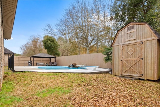 view of yard with a fenced in pool, a gazebo, a patio, and a shed