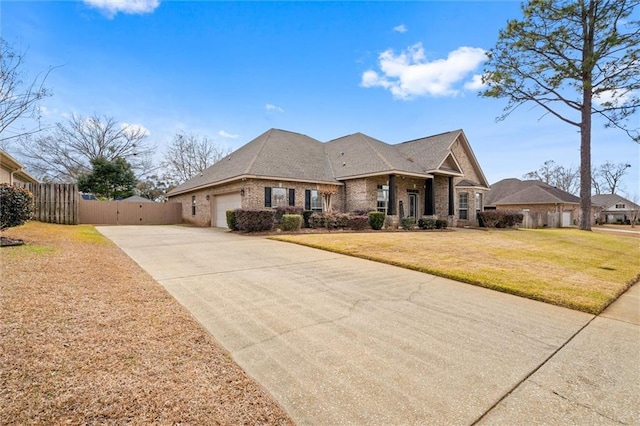 view of front of home with a garage and a front lawn