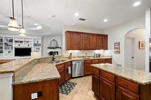 kitchen with sink, dishwasher, a center island, light stone counters, and decorative light fixtures