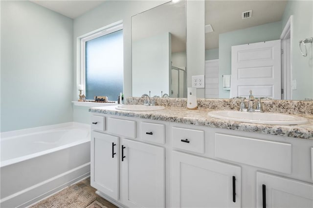 2526 Windmere Dr E, Semmes, AL 36575 - bathroom featuring double vanity, a sink, a bath, and a shower stall