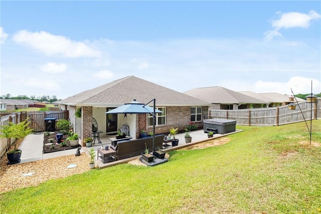 2526 Windmere Dr E, Semmes, AL 36575 - back of property with a fenced backyard, a yard, a patio, and a hot tub