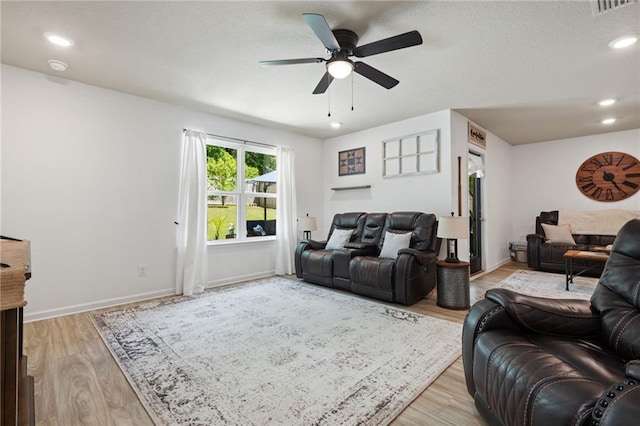 2526 Windmere Dr E, Semmes, AL 36575 - living room featuring light wood-style floors, baseboards, and a ceiling fan