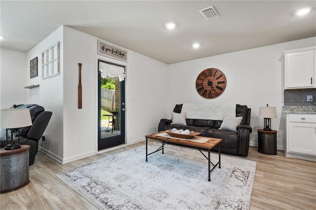 2526 Windmere Dr E, Semmes, AL 36575 - living room with recessed lighting, baseboards, visible vents, and light wood-type flooring